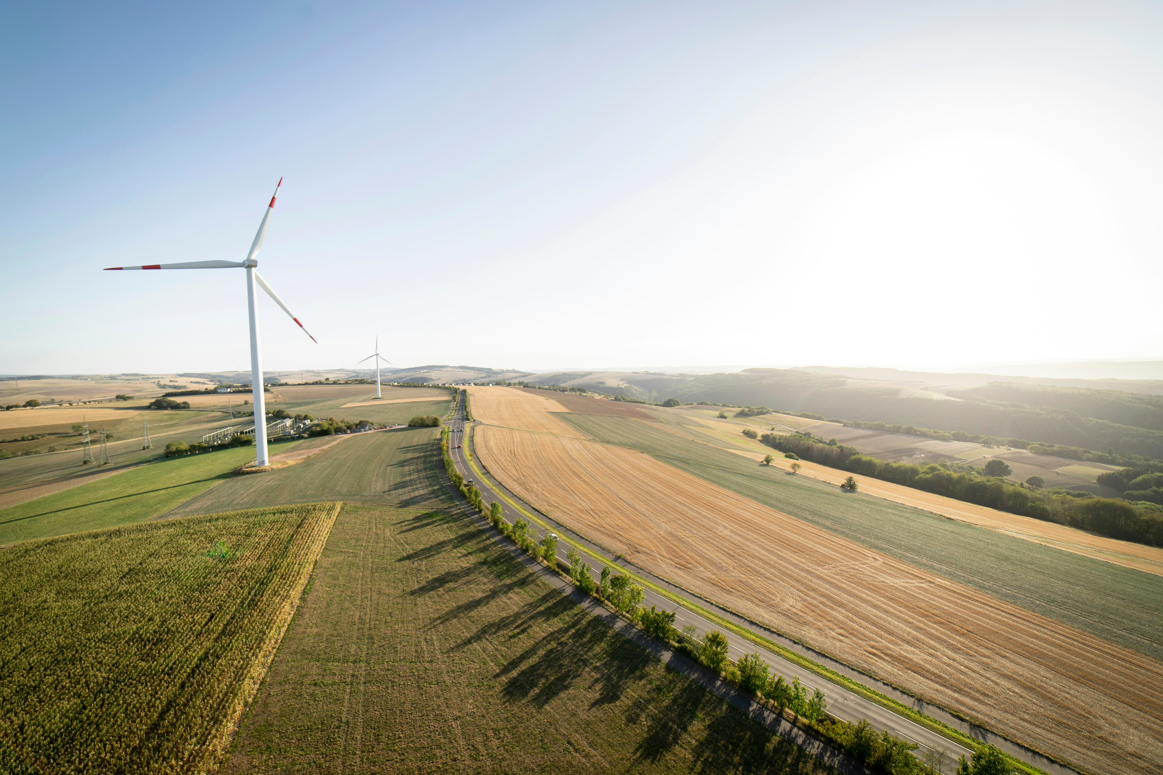 Wind turbines on open landscape captured from aerial drone perspective